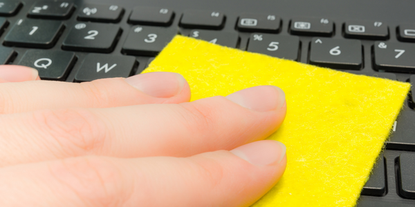 Image showing a hand with microfibre cloth cleaning computer keyboard.